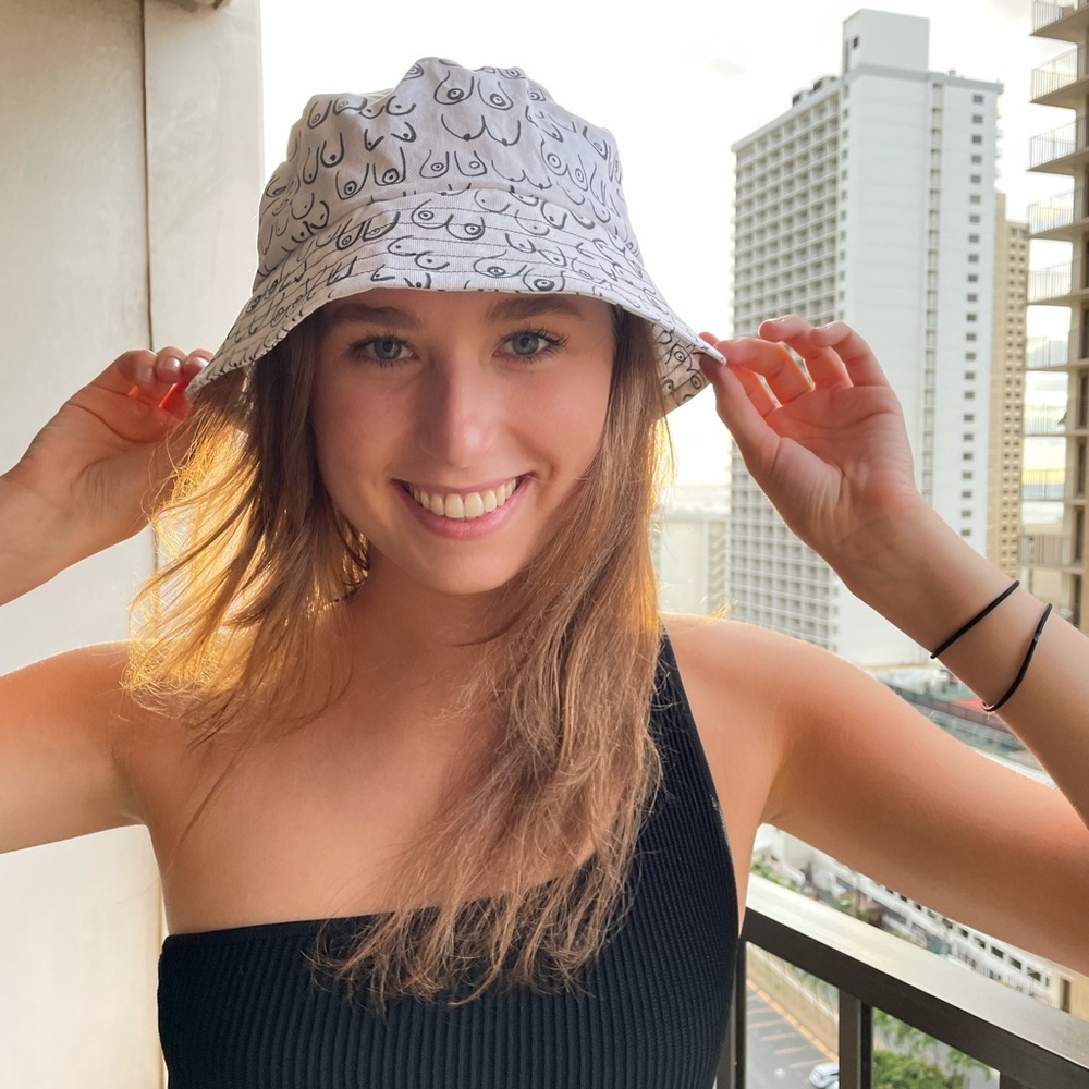 Handmade bucket hat by Cervantes Rave Co. boob design, white and black hat